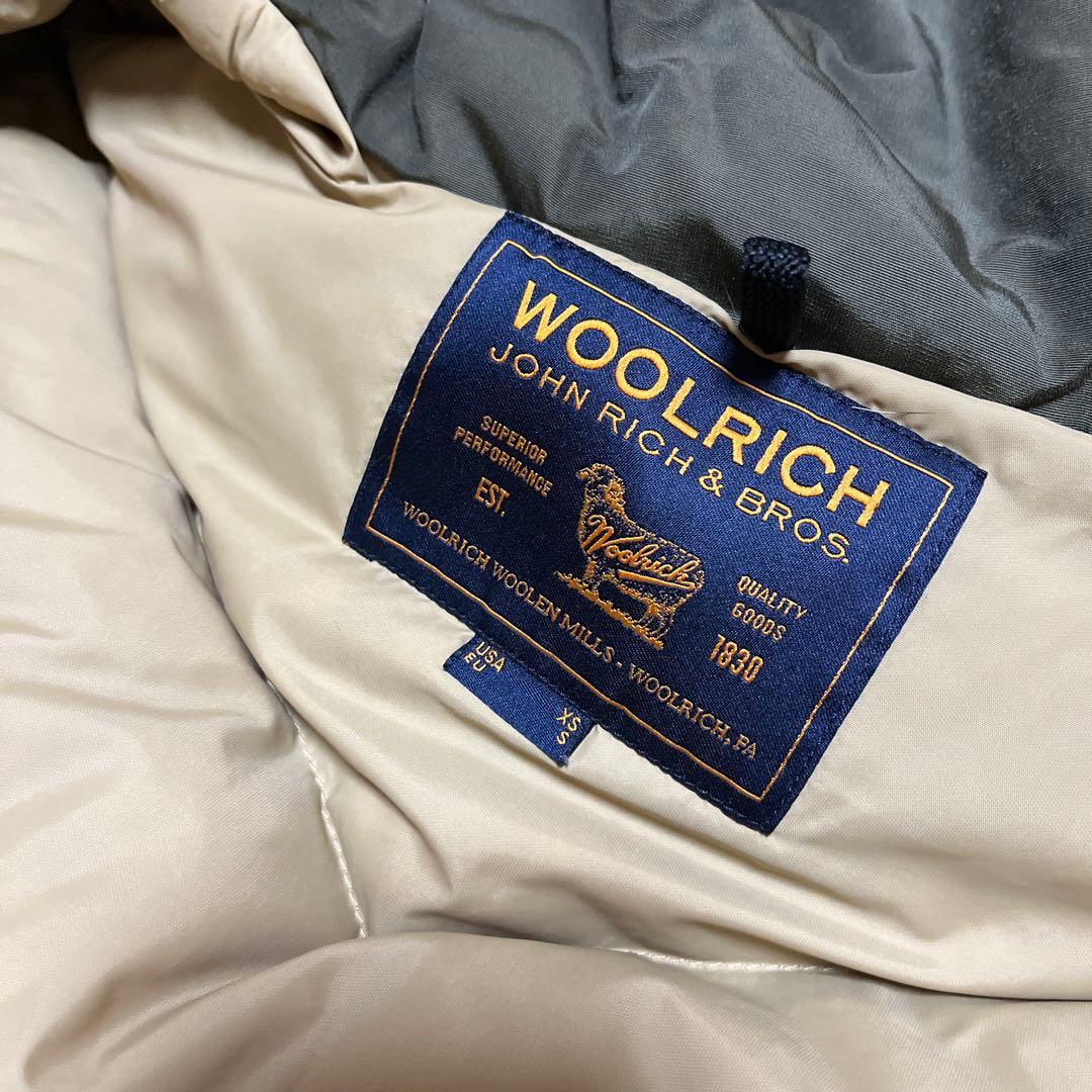 1/31まで。WOOLRICH オリーブ アークティックパーカー