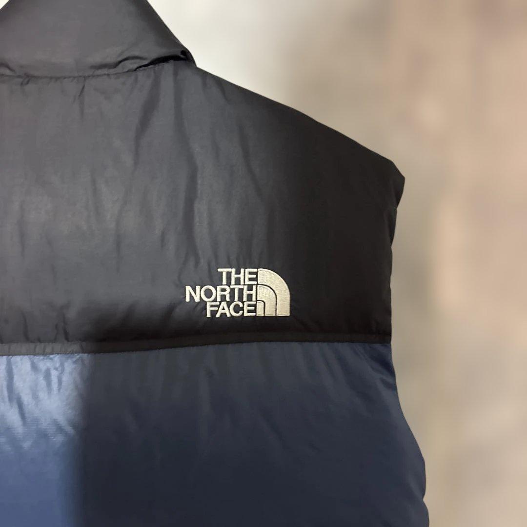 ノースフェイスヌプシダウンベスト700フィル刺繍口ゴドローコード
