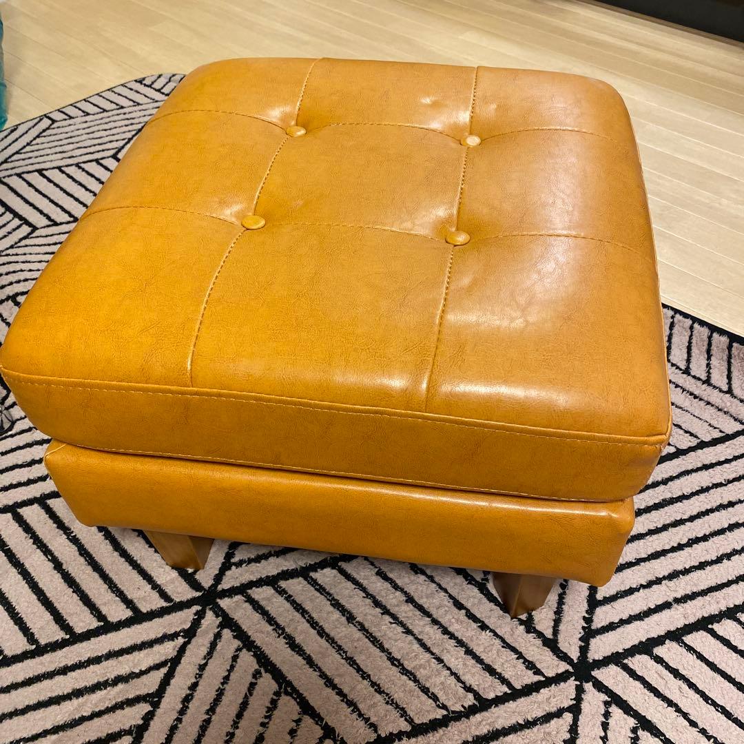 オレンジ色のボタン付きオットマン